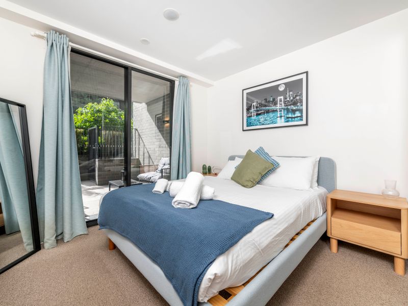 Cozy bedroom with direct access to the outdoor patio. 5. Sunlit second bedroom offering fresh air and garden view