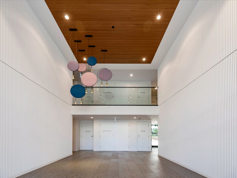 Stylish, hotel-like lobby with high ceilings and playful lighting.