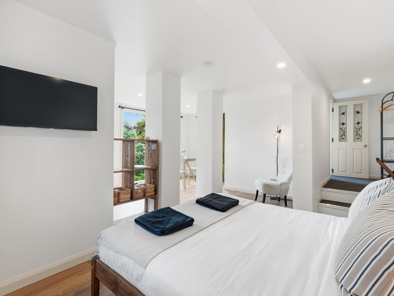 Large open-plan bedroom with storage and modern touches.