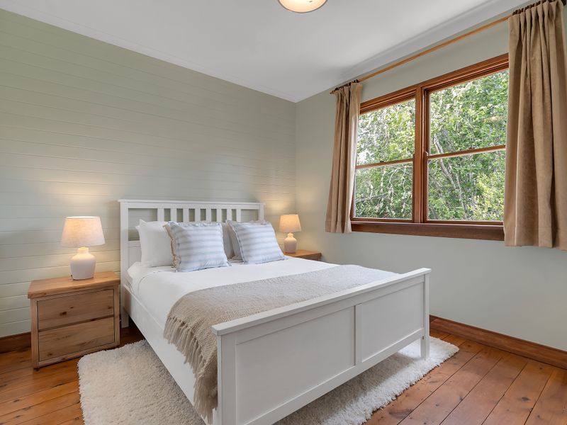 Cozy bedroom with natural light and warm tones.