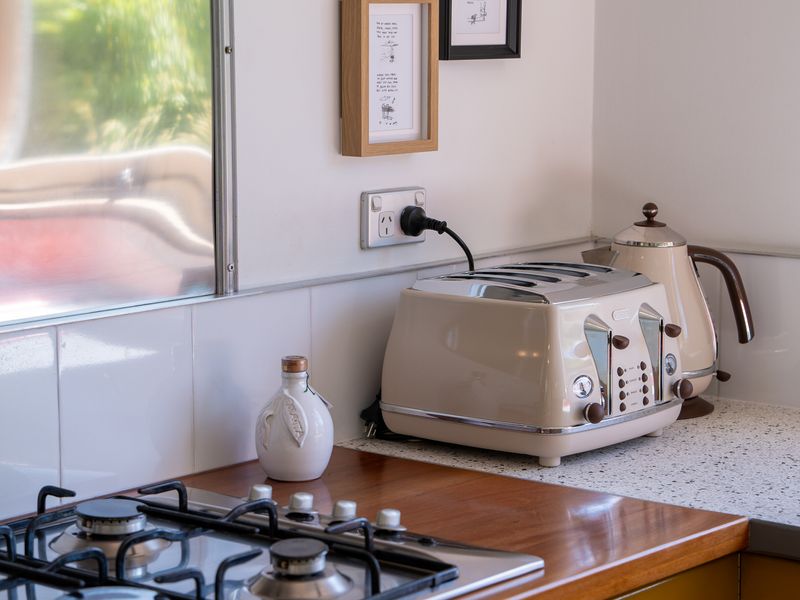 Compact kitchenette setup with toaster and essentials.