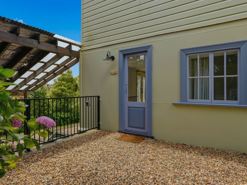Quiet outdoor corner with a seating area wrapped in greenery.