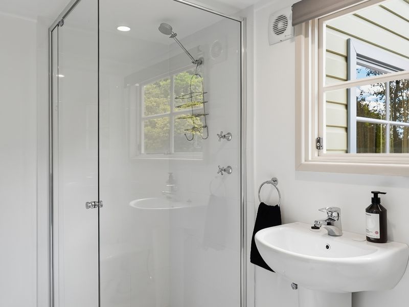 Walk-in shower with clean, minimalist design.