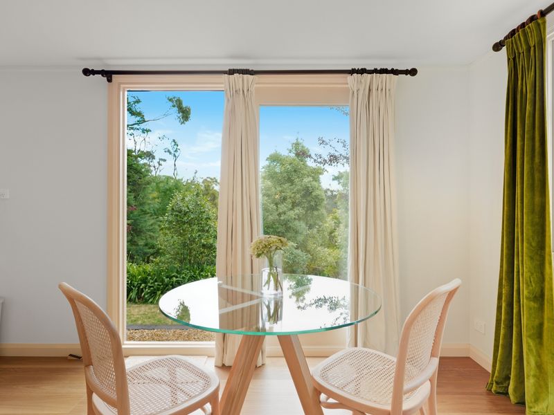 Bright dining nook overlooking lush greenery.