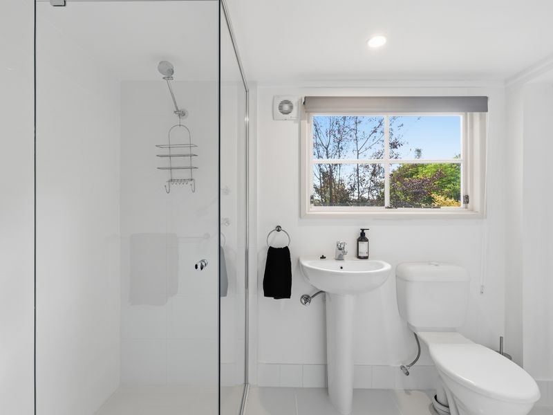Modern vanity area with natural light and essentials provided.