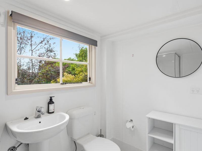 Bright bathroom with a large window and fresh, modern finishes.