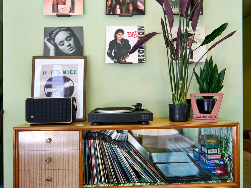 Chic entertainment corner with record player and curated artwork.