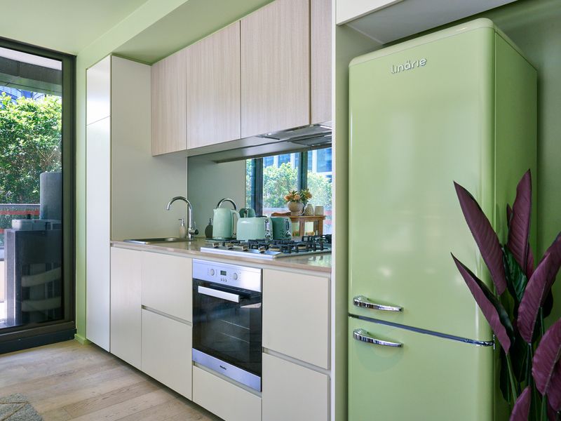 Fully equipped kitchen featuring modern appliances and ample bench space.