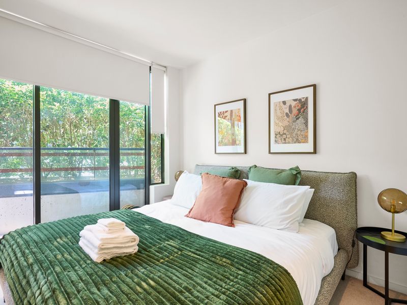 Bedroom with city views and calming tones for a restful ambiance.