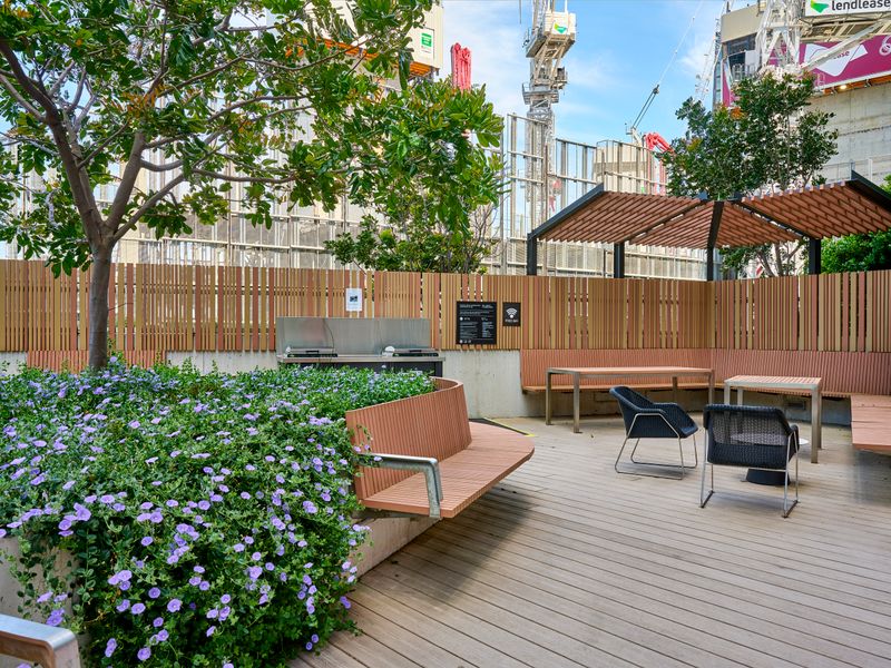 Lush shared courtyard featuring greenery and peaceful seating areas.