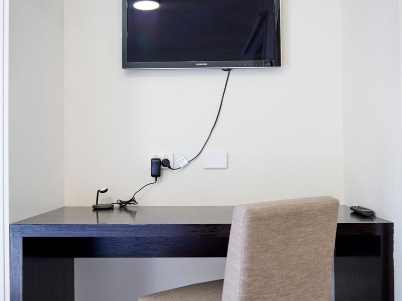 Workspace with mounted TV and charging outlets