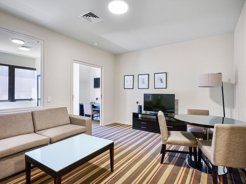 Bright open-plan living area with sofa seating and natural light