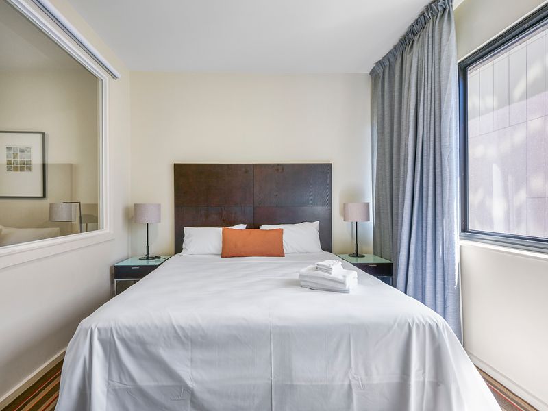 Comfortable queen bed with bedside lighting