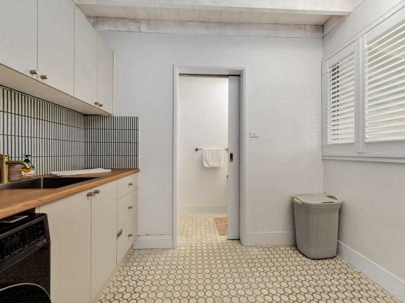 Convenient laundry area with washer and storage