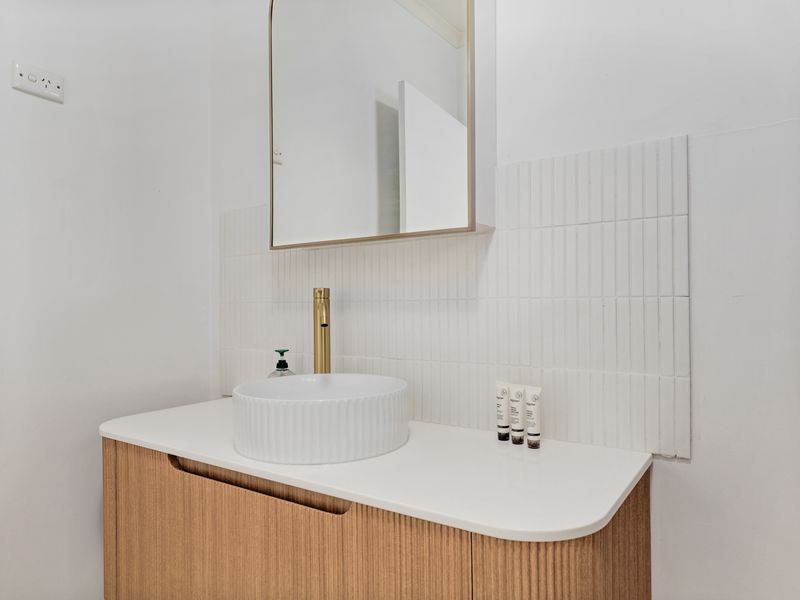 Minimalist sink and vanity with hotel-style touches
