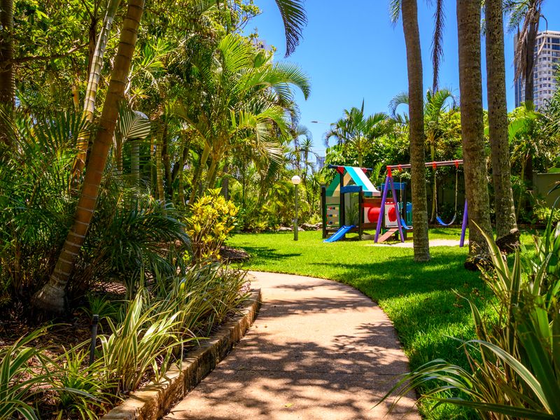 Well-kept garden with a playground for families.