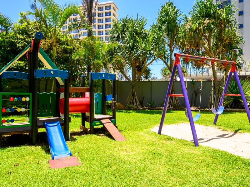 Children’s play area with slide and swings for family fun.