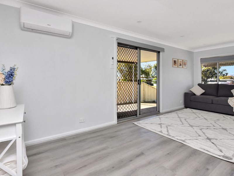 Bright lounge area with sliding door access to the side carport