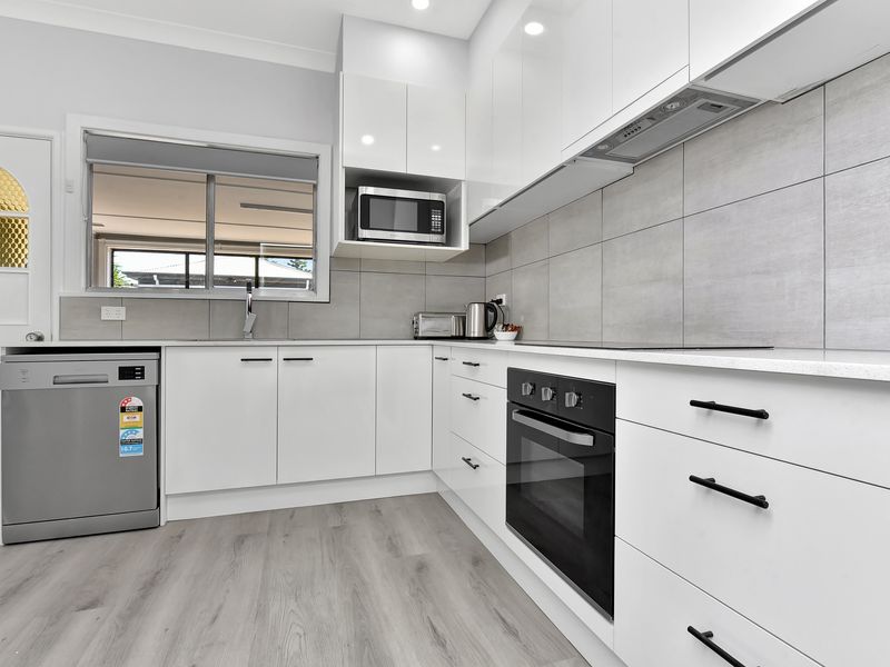 Alternate angle of the kitchen showing appliances and storage