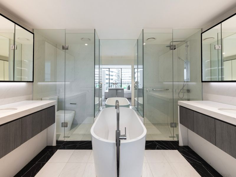 Luxe bathroom featuring a freestanding tub and dual vanities.