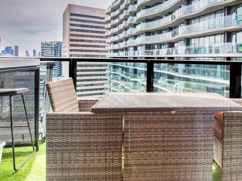 Private balcony with outdoor seating and urban views.
