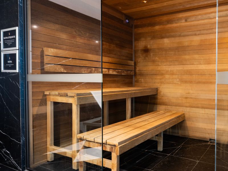 Spacious sauna room with tiered seating for comfort.