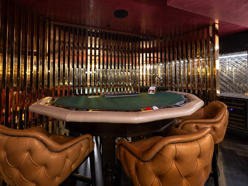Games room featuring a luxury poker table setup.