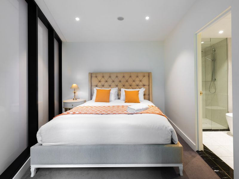 Peaceful bedroom with soft lighting and warm tones.