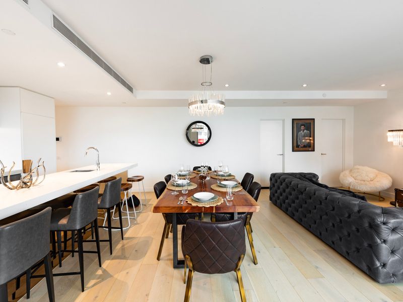 Dining area accented with bold artwork and warm lighting.