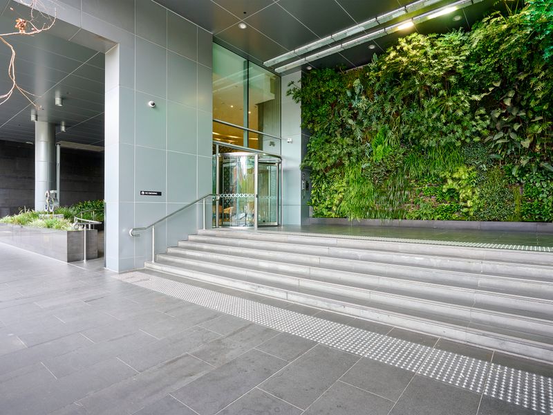 Secure building entry with lush landscaping