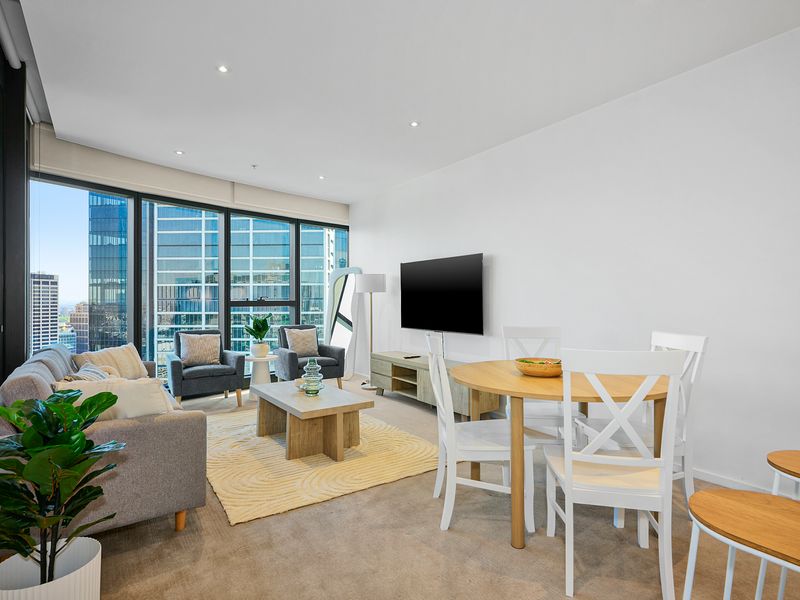 Open-plan living and dining with floor-to-ceiling windows