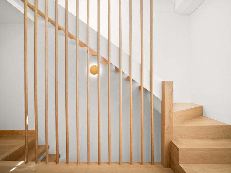 Interior staircase with timber steps and vertical balustrade