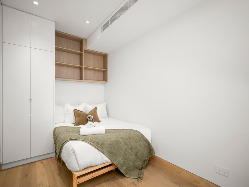 Serene guest bedroom with custom storage and soft natural light