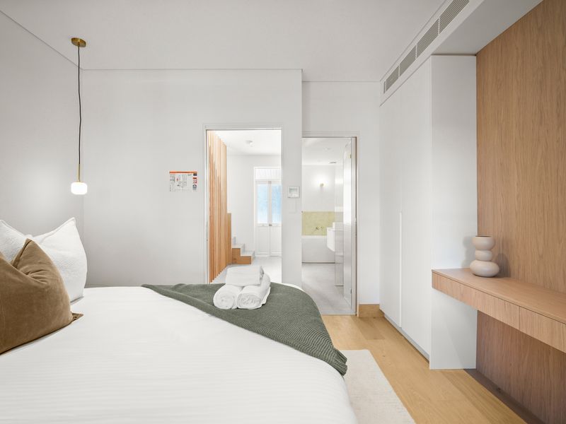 Bedroom with built-in storage and pendant lighting