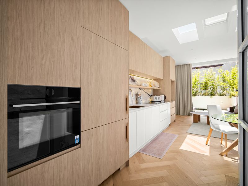 Bright modern kitchen with built-in oven and dining nook