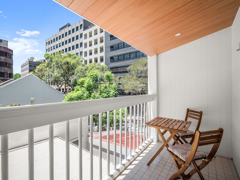 Private balcony with outdoor seating and leafy outlook
