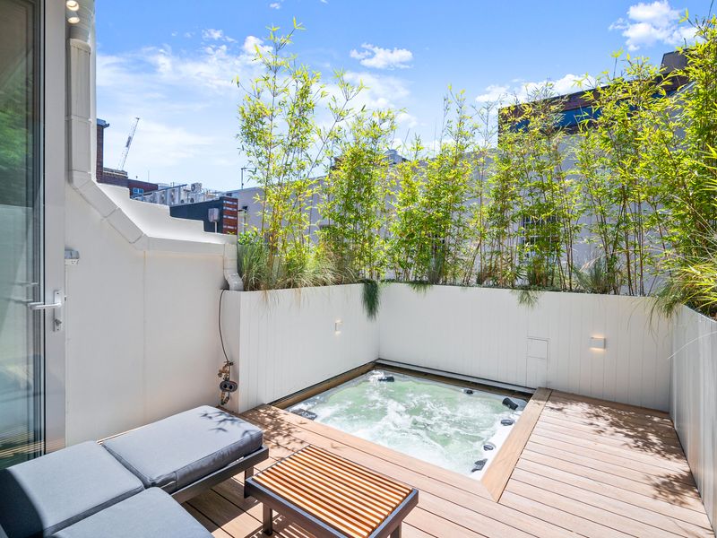 Private outdoor plunge pool surrounded by lush greenery