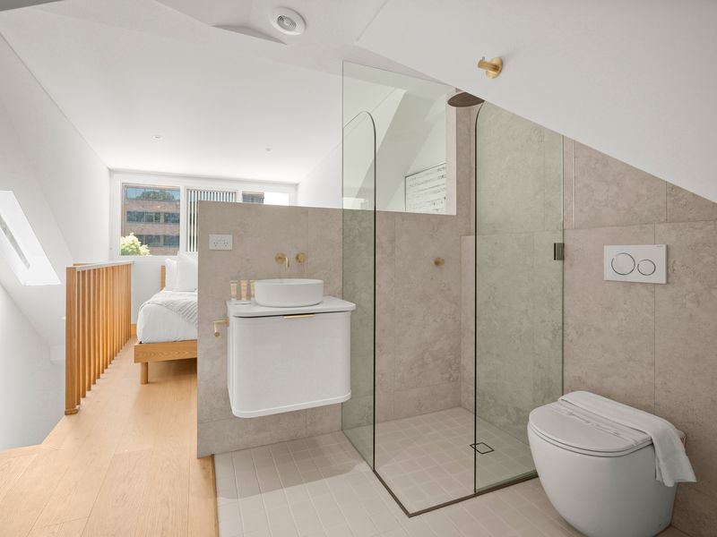 Ensuite bathroom with glass shower and toilet