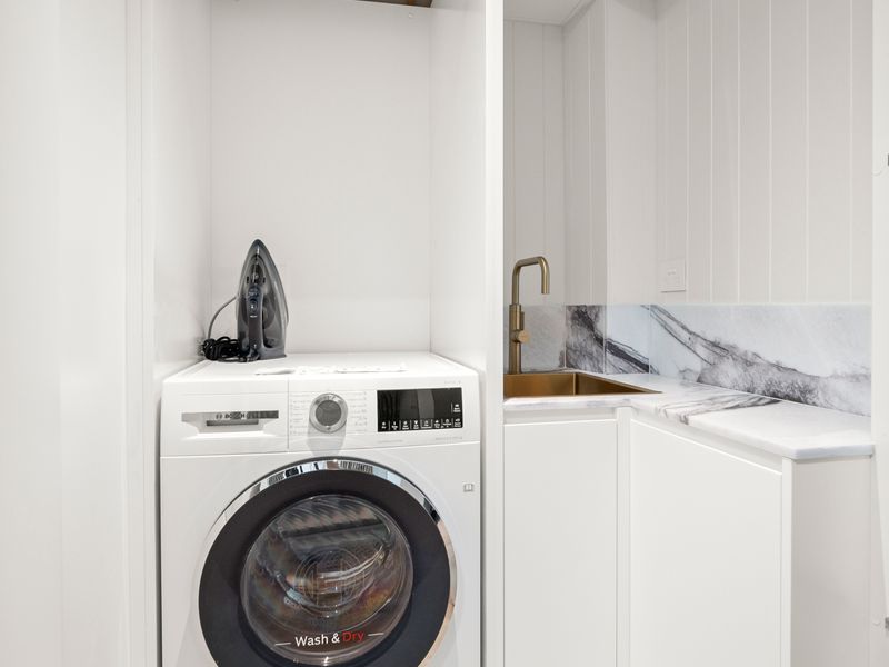 Laundry area with washer, dryer, and utility sink