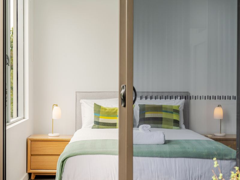 Serene bedroom with calming tones and balcony doors