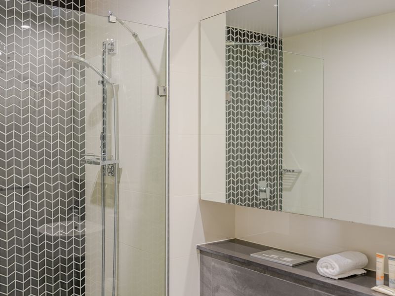 Walk-in shower with sleek, contemporary finishes