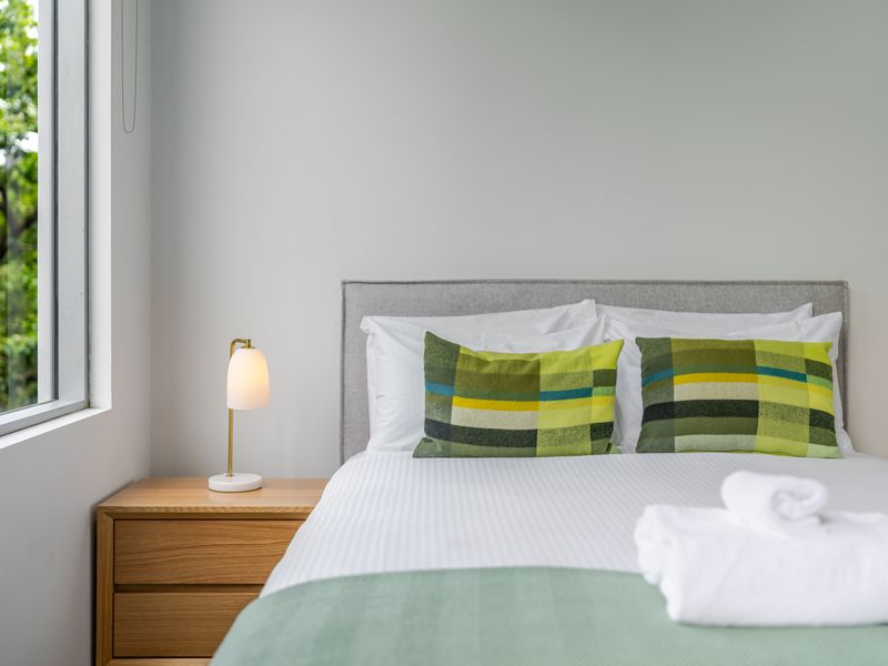 Comfortable sleeping space with hotel-style bedding