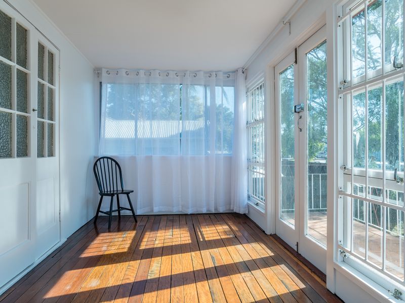 Bright enclosed sunroom perfect for morning coffee and peaceful downtime.