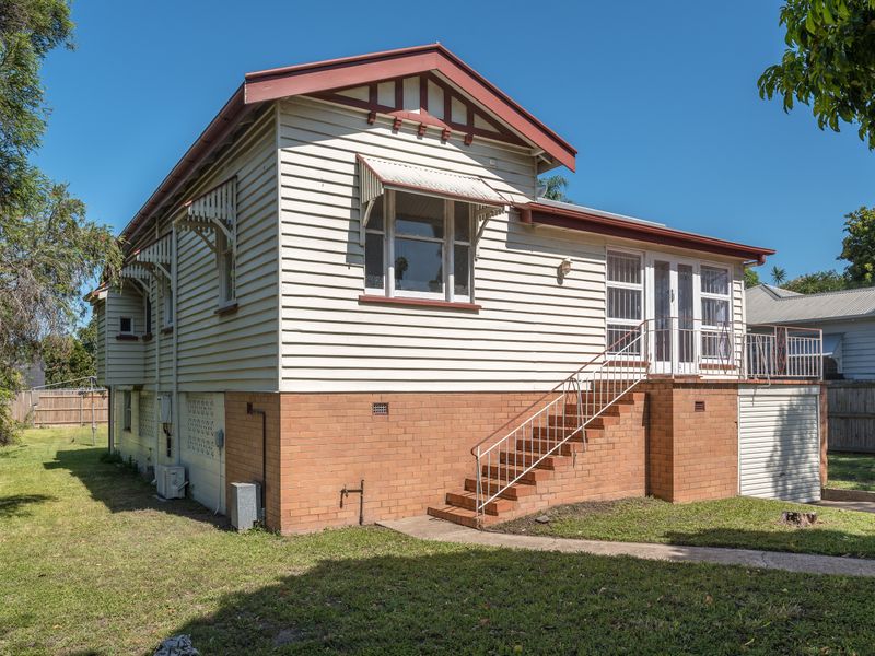 Charming Queenslander-style home with elevated entry and spacious yard.