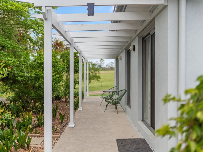 Breezy walkway with seating nook and tranquil garden backdrop