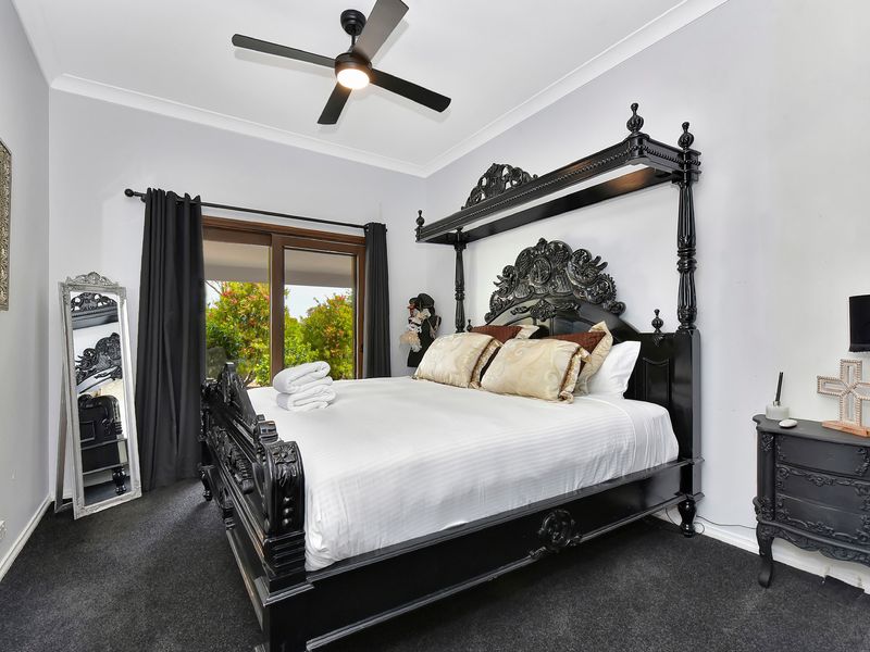 Elegant bedroom with a grand statement bed and garden views