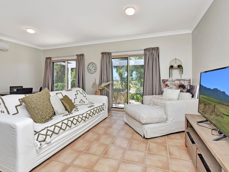 Airy lounge room overlooking the garden for a relaxing stay