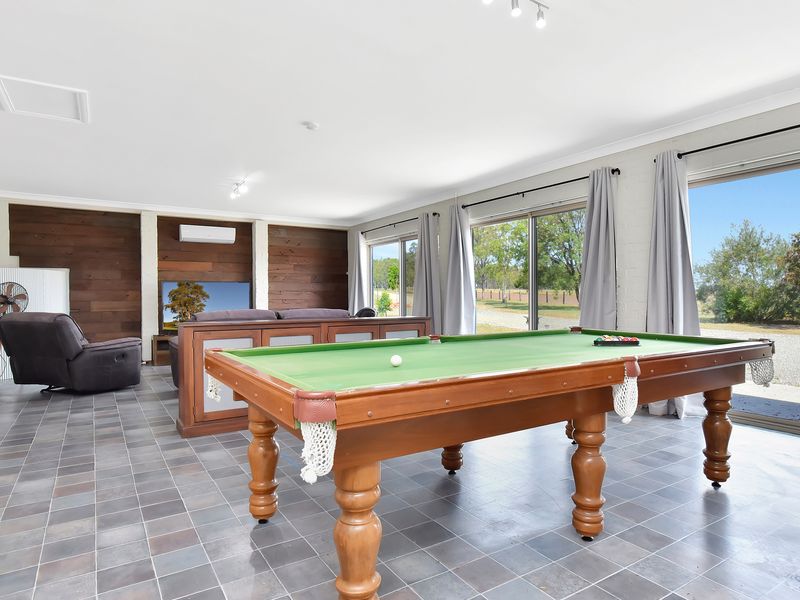 Bright games and lounge room with pool table and garden views