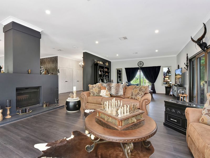 Bright living room with fireplace and seamless indoor–outdoor flow.