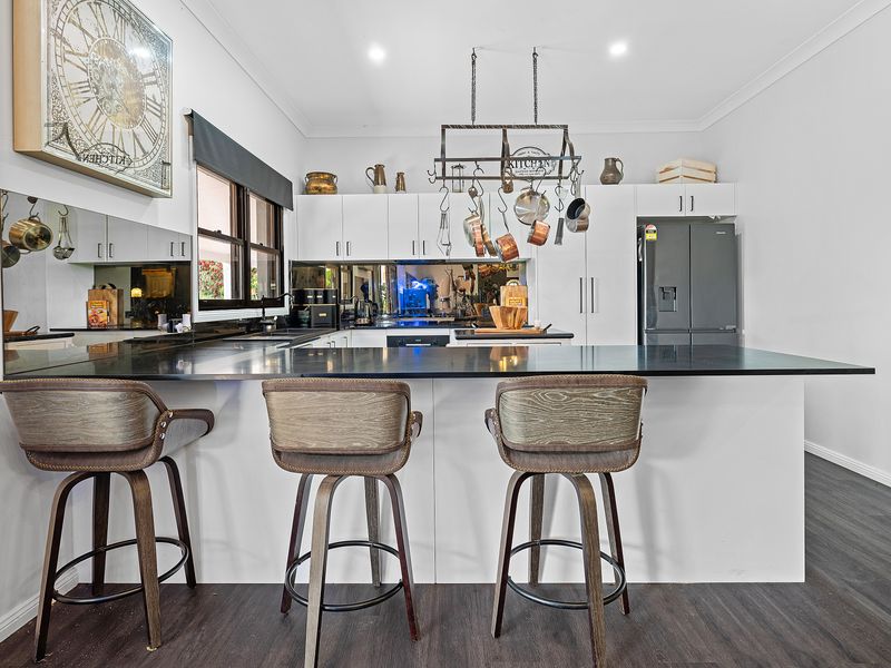 Sleek gourmet kitchen designed for cooking and gathering.